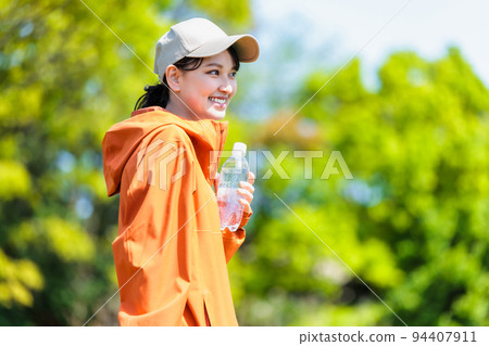 Young woman with plastic bottle for hydration Young woman with plastic bottle for hydration 94407911