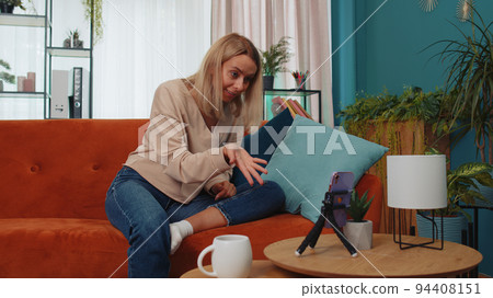 Girl blogger influencer taking selfie on smartphone, make virtual social media video online at home 94408151