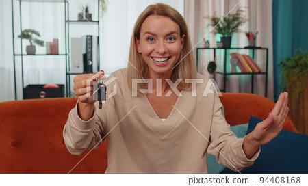 Woman real estate agent showing the keys of new home house apartment, buying or renting property 94408168