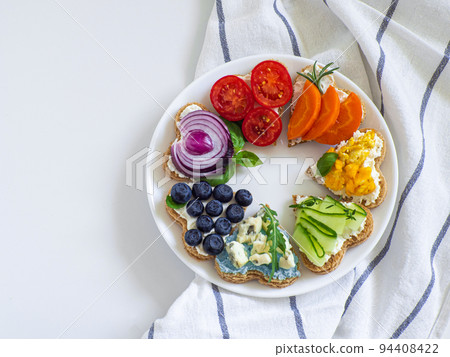 Rainbow sandwiches heart shape on white table 94408422