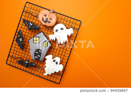 Gingerbread cookies for Halloween celebration are on an orange background 94409667