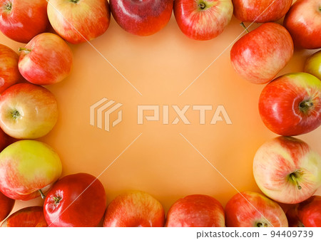 Freshly picked apples are laid out on the edge of the background Freshly picked apples are laid out on the edge of the background 94409739