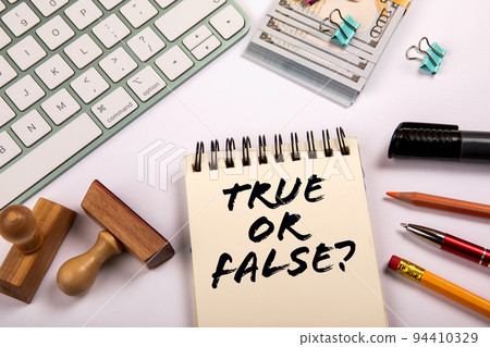 True or False. Money and stationery on a white office table 94410329