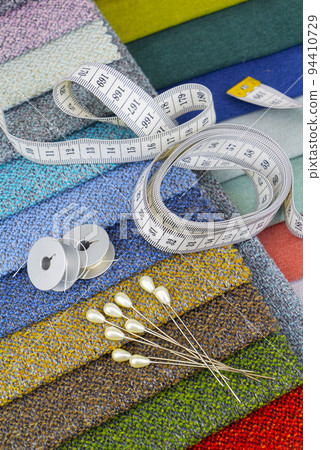 Pieces of cloth with scissors, needle and thread. Tailoring, manufacture of upholstered furniture. 94410729