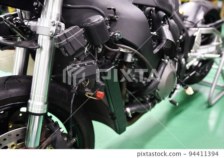 Large motorcycle under maintenance Large motorcycle under maintenance 94411394