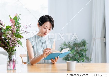 在客廳裡看書的中年女人 94411706
