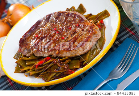 Grilled beef with stewed green beans and pepper 94413085