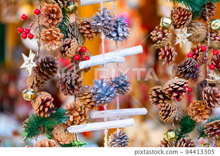 Colorful handmade Christmas decorations hanging on traditional winter fair Colorful handmade Christmas decorations hanging on traditional winter fair 94413305