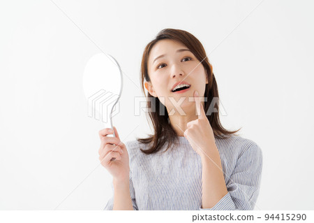 A woman in her twenties doing a dental check 94415290
