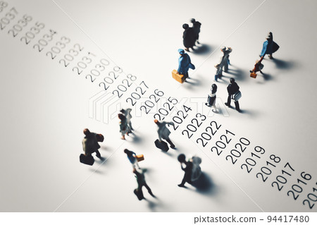 Miniature people walking beside chronology 94417480