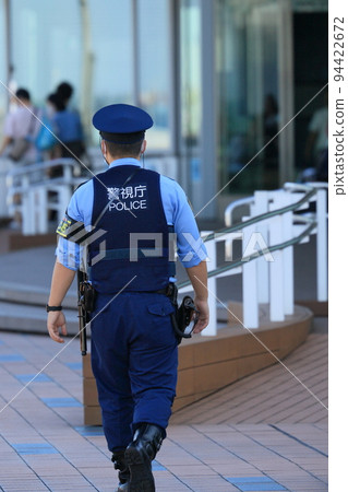 Police officers patrolling the airport Back view Security Metropolitan Police Department 94422672