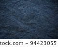 Closeup top view of blue wrinkled jean as a background. Cool tone. 94423055