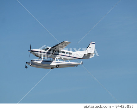 Floatplane flying in the blue sky Floatplane flying in the blue sky 94423855