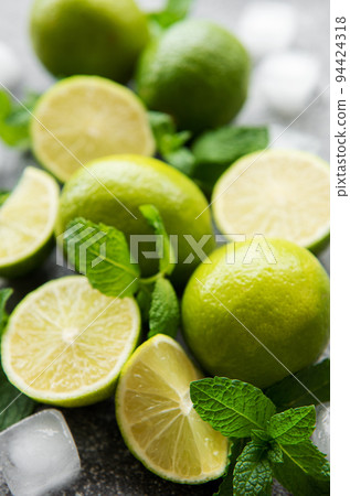 Lime and mint  on a dark background. 94424318