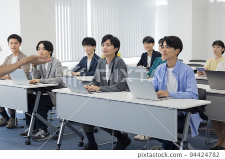 Men and women attending a seminar Men and women attending a seminar 94424782