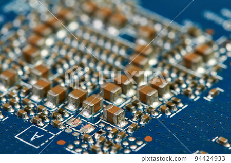 Resistors, capacitors, transistors on an electronic computer printed circuit board 94424933