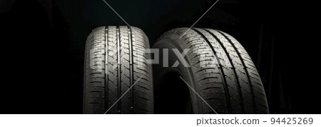 Two new summer wheels on a black tire background graphically panoramic photo 94425269