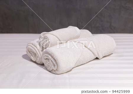 stack of white towel on bedroom 94425999