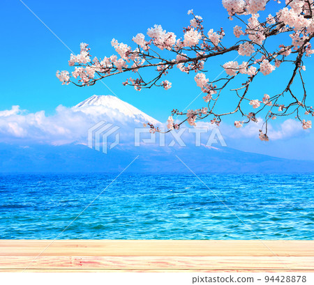 Sacred Mount Fuji, blooming sakura branch, lake and old wooden plank, Japan. Empty wooden table top and scenic with Fujiyama volcano Sacred Mount Fuji, blooming sakura branch, lake and old wooden plank, Japan. Empty wooden table top and scenic with Fujiyama volcano 94428878