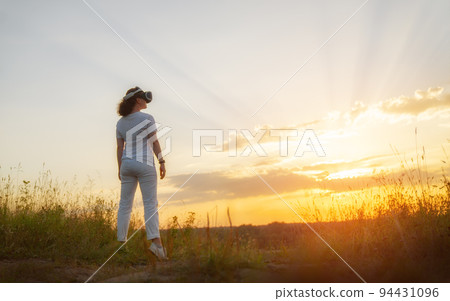 Woman with VR virtual reality goggles Woman with VR virtual reality goggles 94431096