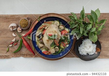 Green curry with Chicken and Thai eggplants (Kaeng khiao wan) in Ceramic bowl served with Rice noodles. Green curry with Chicken and Thai eggplants (Kaeng khiao wan) in Ceramic bowl served with Rice noodles. 94432110