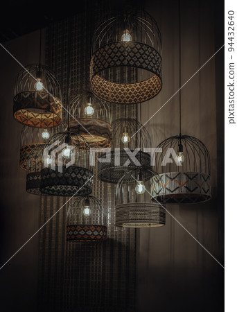 Softly shining hanging many lamps decor design for home on dark background. Softly shining hanging many lamps decor design for home on dark background. 94432640