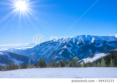 Sun Over Empty Ski Slope and Mountain Relief 94433233