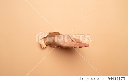 Close-up of empty man hand on brown background Close-up of empty man hand on brown background 94434175