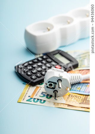 Electric plug, calculator and euro money on blue background. Concept of increasing electric prices. 94436060