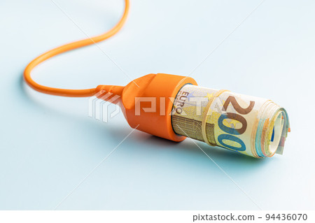 Electric socket and euro money on blue background. Concept of increasing electric prices. Electric socket and euro money on blue background. Concept of increasing electric prices. 94436070