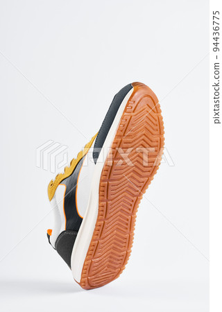 Trendy fashionable sneakers with sole on white background. Stylish sports casual shoes. Creative minimalistic layout with footwear 94436775