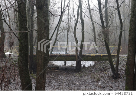 Bridge in a foggy gloomy forest 94438751