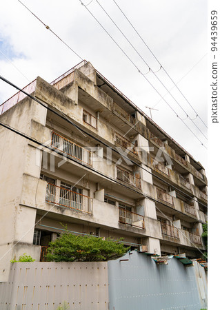 Abandoned condominium that has become dilapidated and uninhabited 94439659