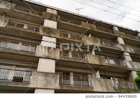 Abandoned condominium that has become dilapidated and uninhabited 94439660