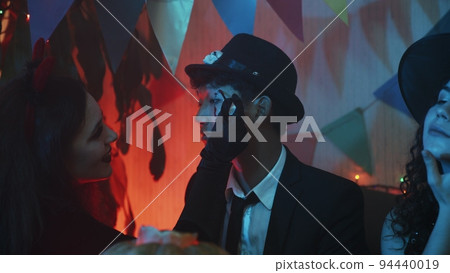 A group of friends celebrate Halloween by doing each other a creepy makeup 94440019