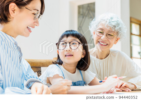 A family watching over an elementary school girl studying A family watching over an elementary school girl studying 94440352