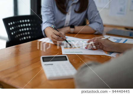 Close up business colleagues discussing financial documents. 94440445