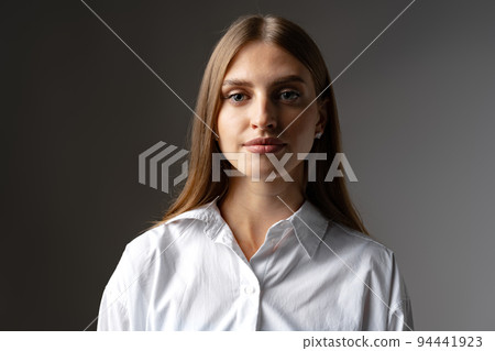 Thoughtful businesswoman portrait on a dark gray background 94441923