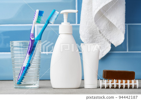 Soap and toiletries on shelf in blue bathroom 94442187