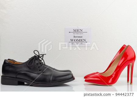 Classic black mens shoes and red high heel womens shoes. Men to the left because women are always right inscription. 94442377