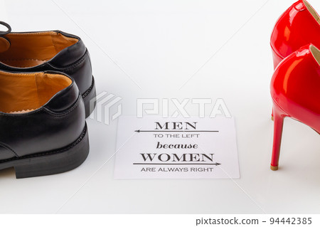 Men to the left because women are always right. Mens and womens shoes on white surface. Men to the left because women are always right. Mens and womens shoes on white surface. 94442385