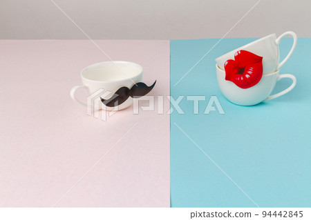 White ceramic cups decorated with moustache and lips. Cute romantic card for valentines day. 94442845