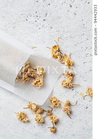 Filter tea bag with chamomile flowers. Ayurveda drink, healthy lifestyle, remedy for insomnia. 94442933