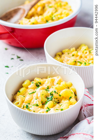 Mac and cheese in white bowl. Traditional American food. 94442996