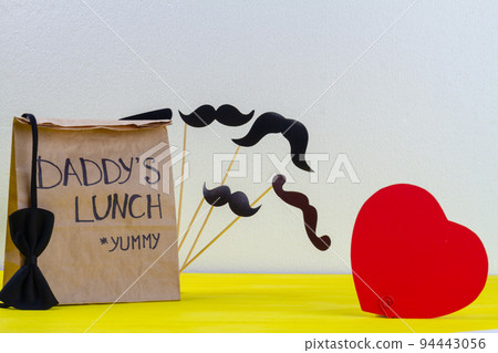 Paper bag for daddy on white background. Red heart and moustache. Paper bag for daddy on white background. Red heart and moustache. 94443056