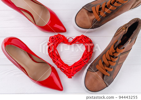 Top view of mens and womens shoes on white desk. Love or marriage concept. 94443255