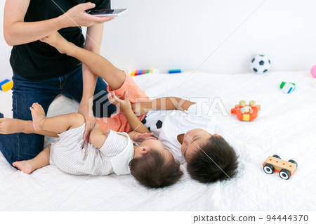 Playing with family Parents and children interacting Playing with family Parents and children interacting 94444370