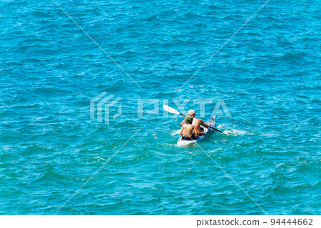 Adult Man and a Young Boy Kayaking in the Blue Water - Liguria Italy 94444662