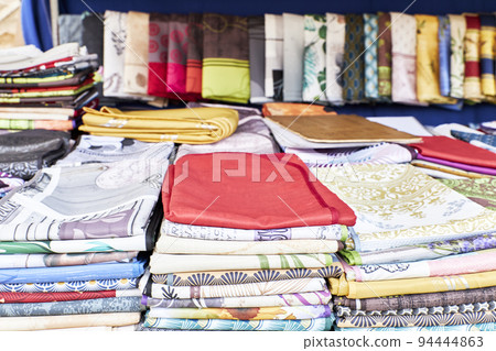 View of fabrics in a store stall with blur effect in the background. Fashion concept View of fabrics in a store stall with blur effect in the background. Fashion concept 94444863