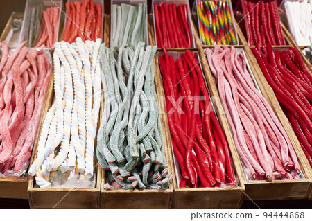 Variety of jelly beans and candies in a store. Unhealthy and fattening concept Variety of jelly beans and candies in a store. Unhealthy and fattening concept 94444868
